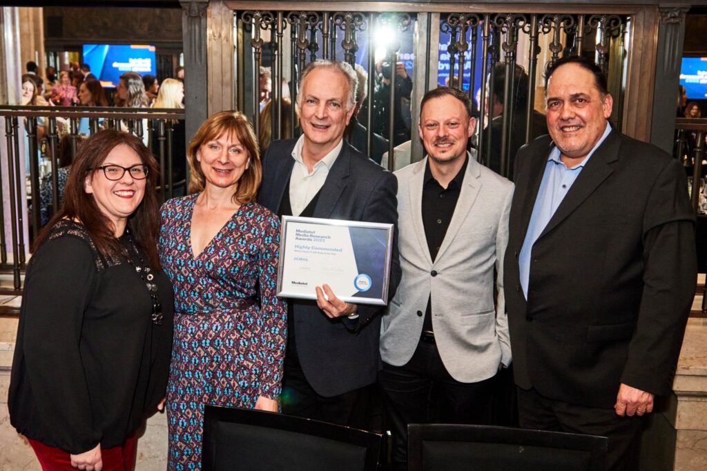 Photograph of the JICMAIL team at the Adwanted Research Awards. There are 5 people smiling and holding a Highly Commended awards certificate